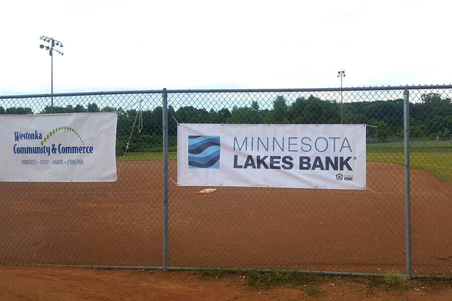 Minnesota Lakes Bank banner at a local baseball field