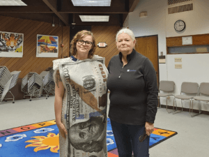 Brittany Bennis and Rose Espiritu teaching Hilltop Primary School classes about banking.